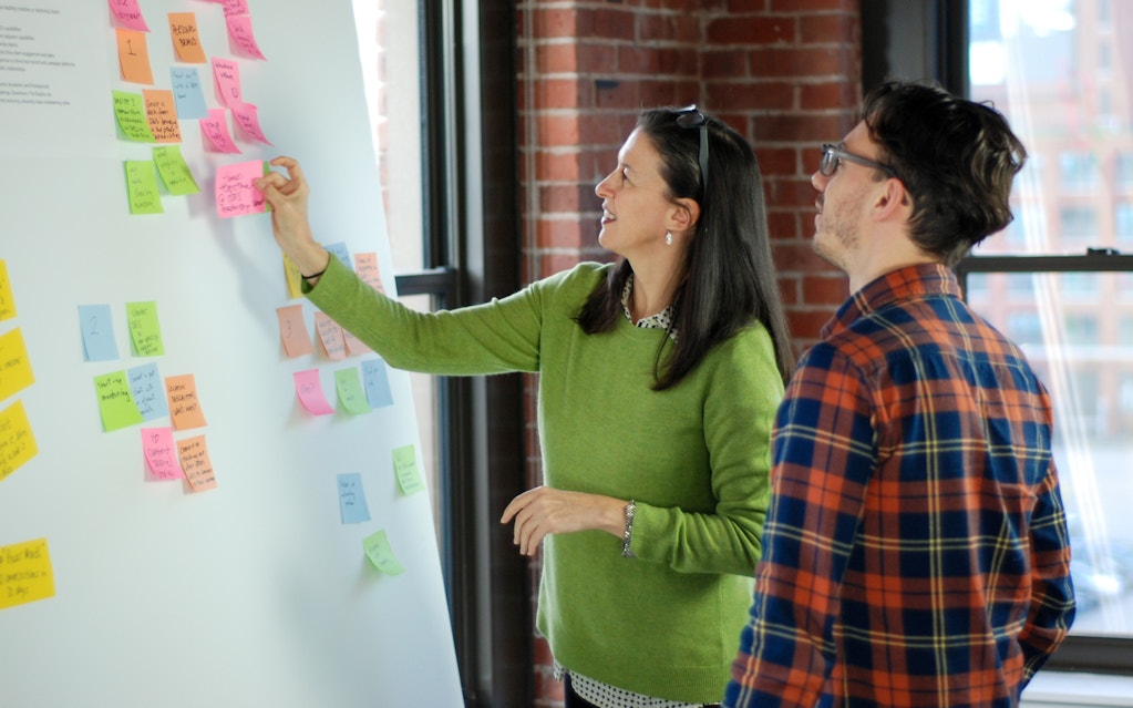 Melanie and a designer working on a brainstorm session