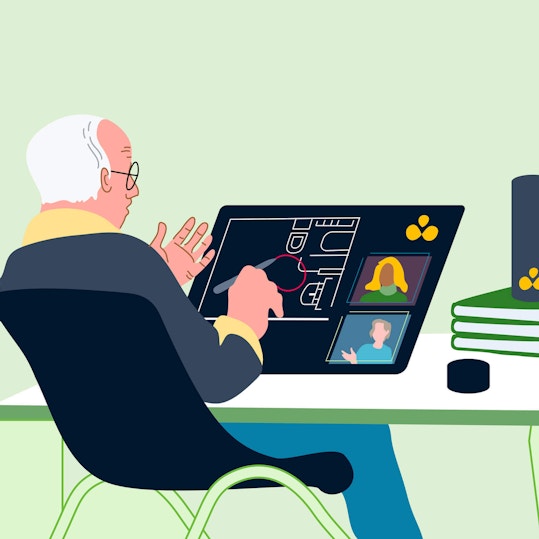 Person working at desk on touchscreen tablet with smart speaker