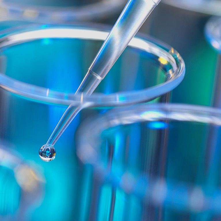 Analytical chemistry sample being pipetted into test tube for analysis in laboratory