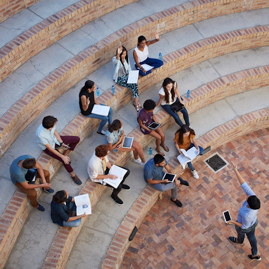 Students having class in outside auditorium