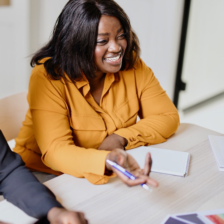 Business people discussing graphs on the table with female boss team leader