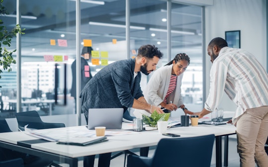 Colleague working together in a meeting room standing
