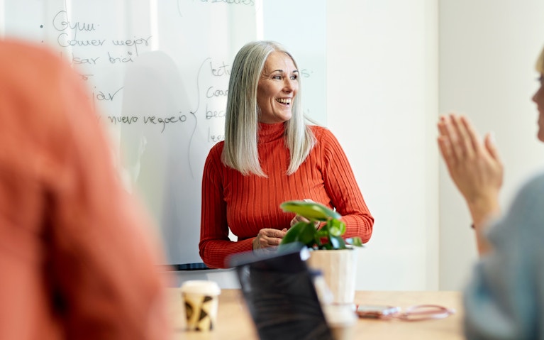 Woman presenting to a team.
