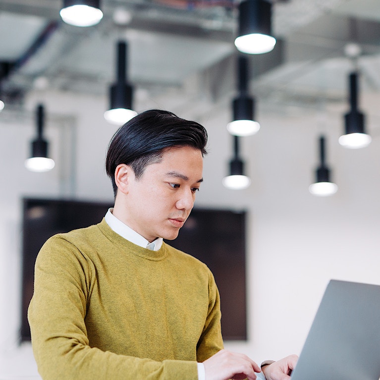 A man working on a laptop.