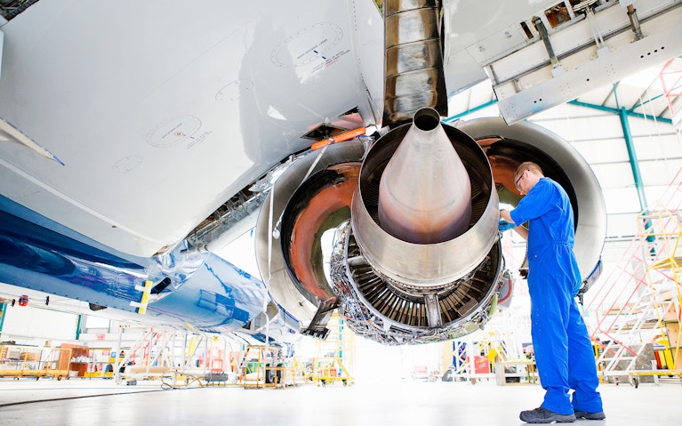 Person repairing aircraft engine