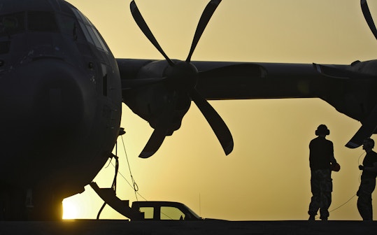 Standing near a helicopter