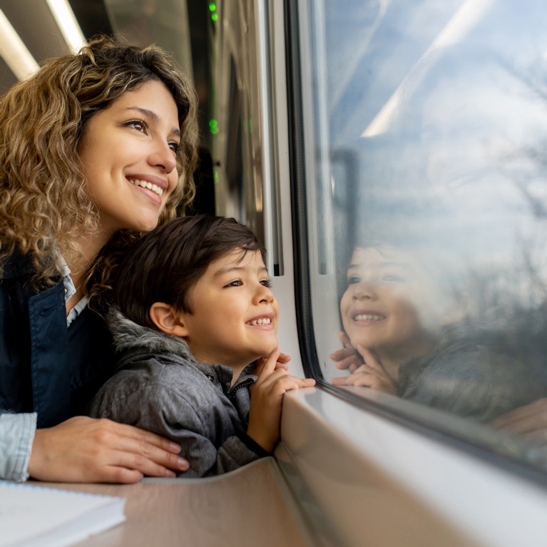 Mother and child on train looking out at countryside