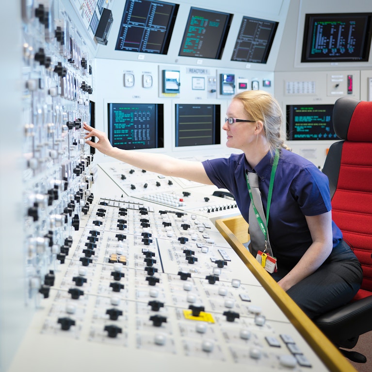 Female operator in nuclear power station control room simulator