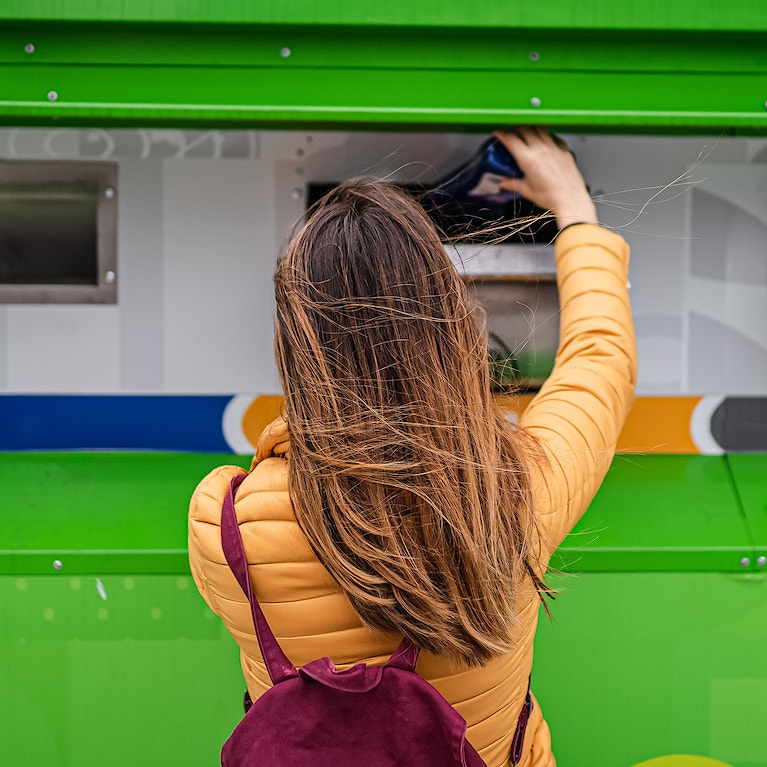 A woman recycling.