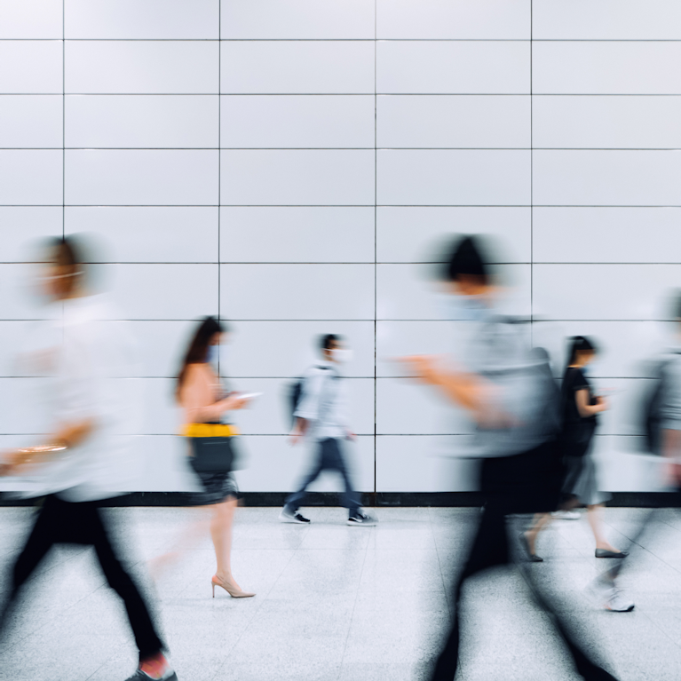 Commuters moving through busy train station